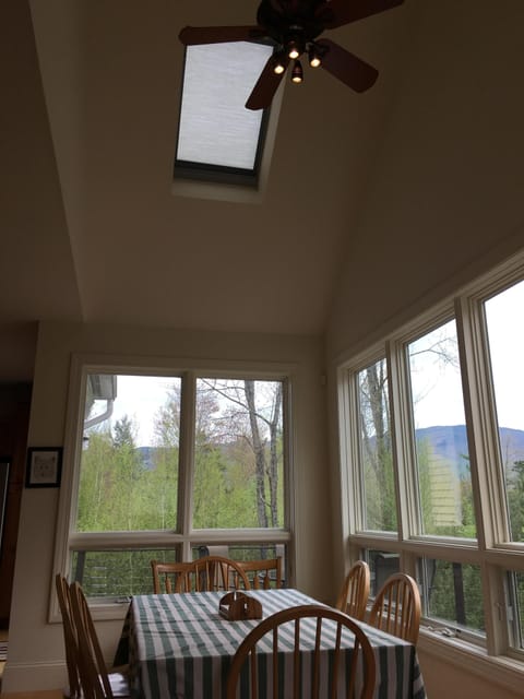 Sky light and ceiling fan over dining room table
