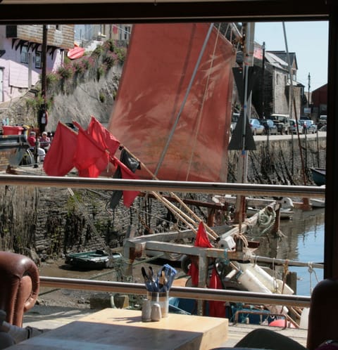 The red sail of a Cornish fishing boat viewed from the comfort of The Sharksfin