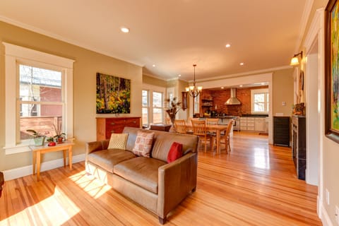 Open floorplan with original wood floors, exposed brick and gas fireplace.