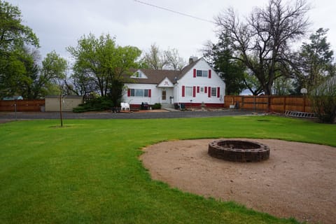 Farm house with group fire pit in the foreground
