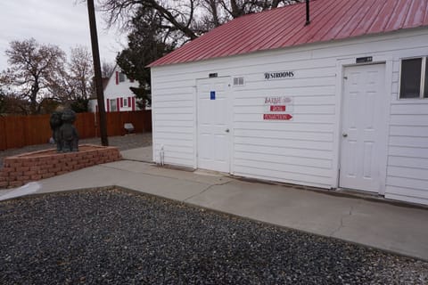 Two outdoor restrooms next to the farm house