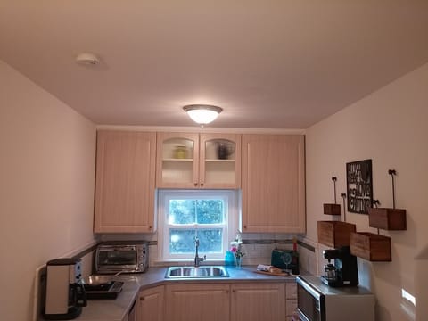Kitchen w/ microwave, induction cooktop, toaster oven, coffee & espresso makers
