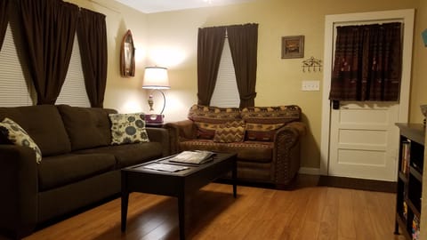 Living room with 50"flat screen and full size pull out sleeper sofa. Internet