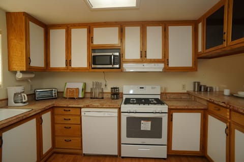 Kitchen – Well stocked with cookware, condiments, spices and small appliances