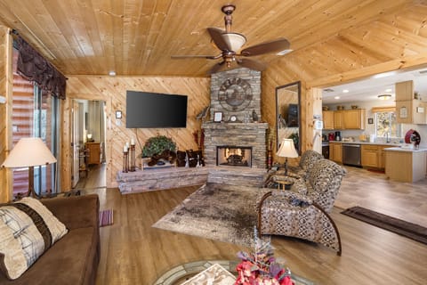 Knotty Pine Great Room with Gas Fireplace and a 65 inch flatscreen tv.
