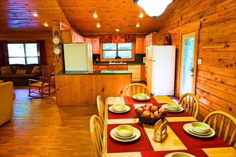 View of dining table, side entrance door, and kitchen