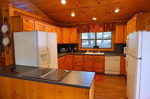 View of kitchen (two refrigerators, double ovens, smooth-surface stove)