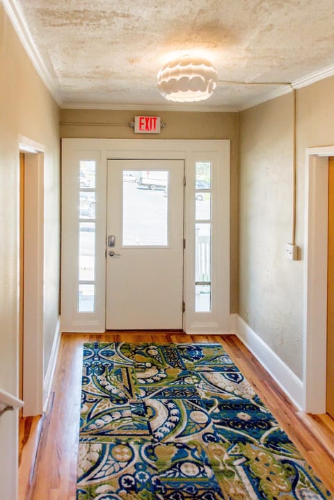 The apartment building's front door provides access to an interior set of stairs, is common space.