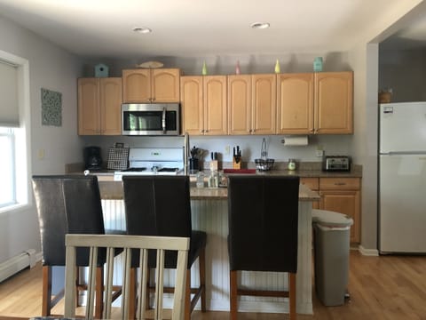 Fully equipped kitchen with additional seating at island. 