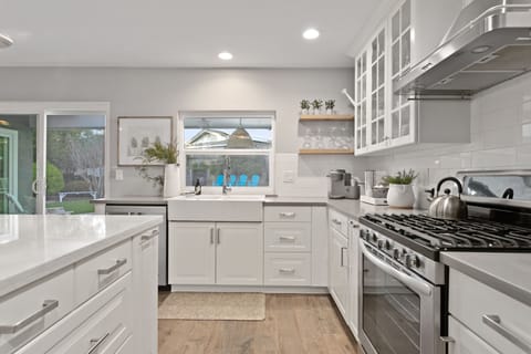Kitchen with a view of outdoor dining + backyard.