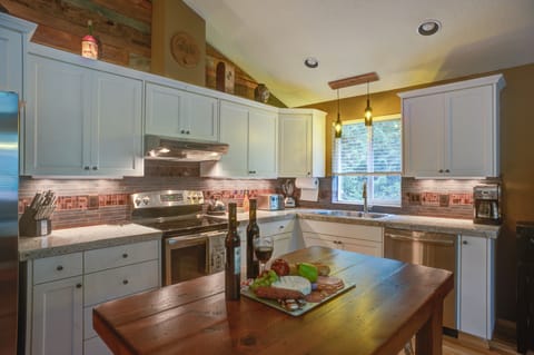 Looking into updated kitchen with an island made from wine staves