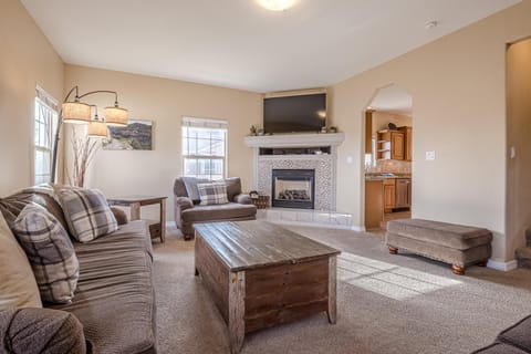 Relax and unwind in this spacious living room, featuring cozy seating, stylish decor, and plenty of natural light.