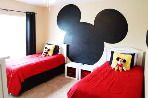 Mickey twin room with toys in nightstands and large chest of drawers.  