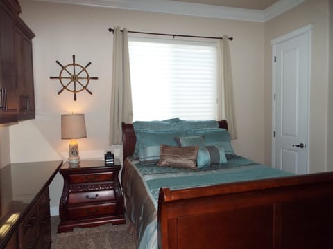 Queen Bed, night stand, large window with dark shades if needed, closet, alarm..