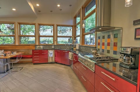 Gourmet kitchen with gas stove and large windows with beautiful views