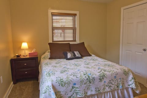Bedroom 1, queen size bed, dresser, tv.