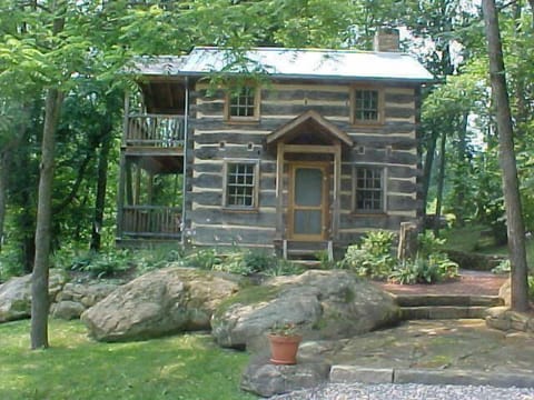 Historic log house cabin in the summer.
