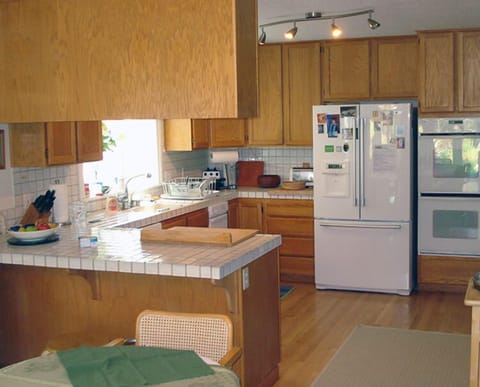 Kitchen with double ovens, Thermador gas stove.