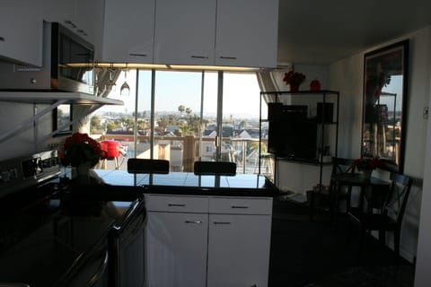 View from the kitchen to the terrace equipped with gas grill and great views!