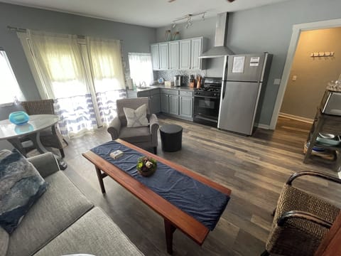 Main living with full kitchen. Private courtyard with coastal breeze invites.