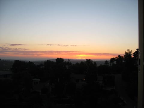 Sunset view over city lights and pacific ocean beyond