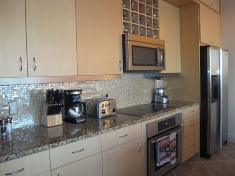 Full kitchen with stainless steel appliances and granite counter-tops 