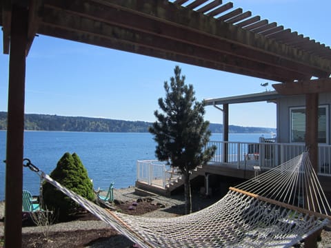 Relax on the hammock as sail boats pass by.