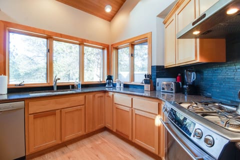 Gourmet kitchen with views of Woodlands course, deck, hot tub.