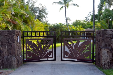 Front gate welcomes you into a private, secure one acre lot
