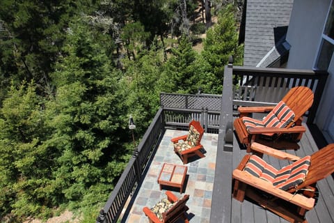 Two decks overlook forest with view of ocean