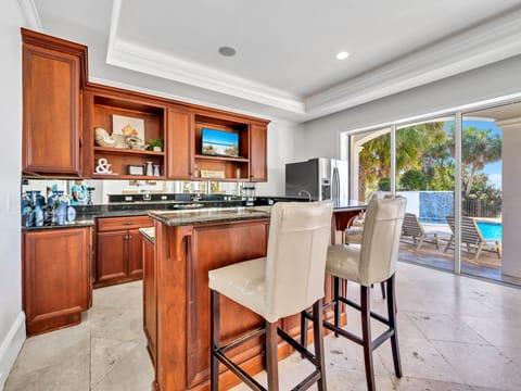 Hang Out in The AC At This 1st Floor Bar Area With Mini Fridge And An Ice Maker With Great Sightlines Of The Pool