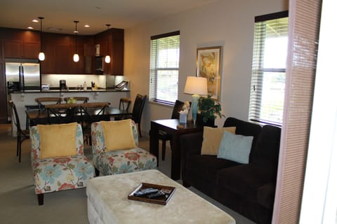 Living Area with couch, chairs, overlooking dining table and chairs and kitchen