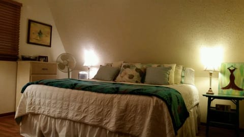 Master bedroom has comfortable bed with seating area and nice size closet.