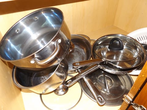 Lots of Pots & Pans along with cooking utensils
