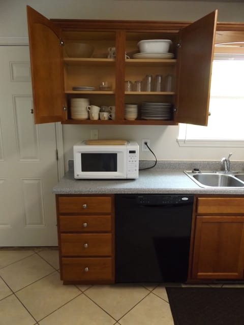 Fully equipped kitchen with dishes, pots, pans, glasses, microwave & Dishwasher