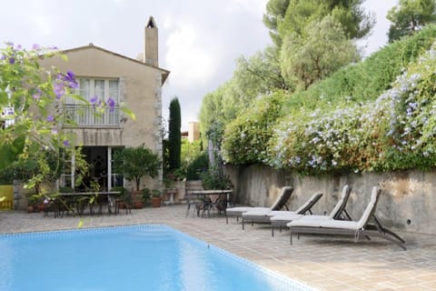 Pool. Large mosiac al fresco dining table. Doors to kitchen. Windows to bedroom.