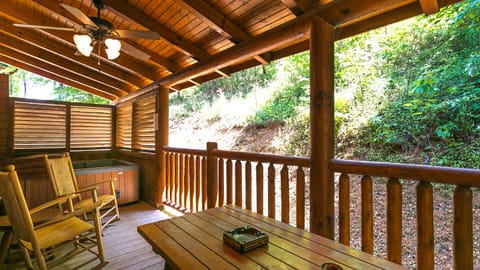 Covered Back Porch with Large Hot Tub, Sauna, Picnic Table, and Rocking Chairs
