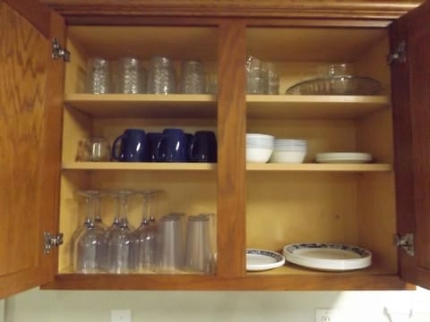 Kitchen is fully stocked with dishes, pots & pans, and cooking utensils