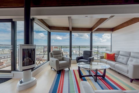 Living area with expansive views of harbor and city.