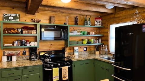 Renovated kitchen with newer appliances and granite countertops