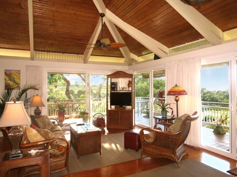 Gorgeous rattan furnishings, high ceilings, skylights create open, airy ambiance