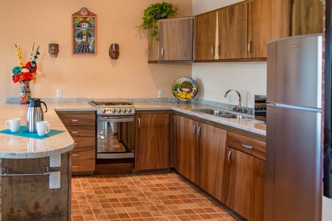 Kitchen with granite counters and parota wood cupboards