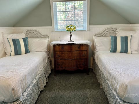 Upstairs- Comfortable twin beds separated by a privacy curtain