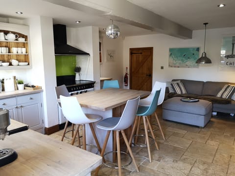 KITCHEN WITH BREAKFAST TABLE AND SOFA.