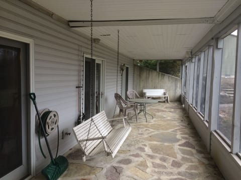 Patio of guest area. Screened in and where you enter to access your rooms.