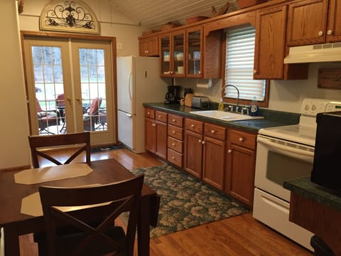 Large Kitchen has everything you need to cook and access to screened in porch.