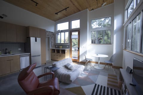 Den with vaulted wood ceilings, full kitchen and separate entry.