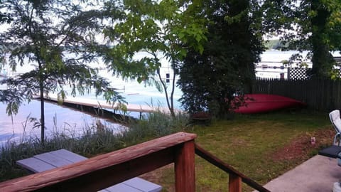 Back yard with private dock and patio. Has fire ring and grill.