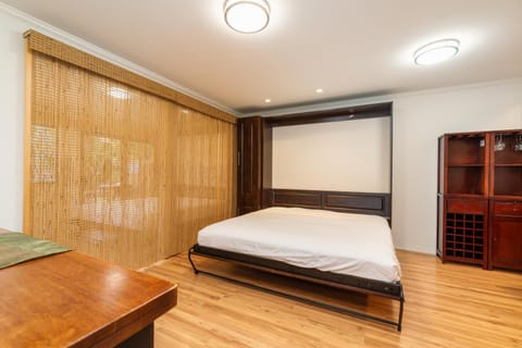 Two king murphy beds on the first floor that are separated with bamboo slider.