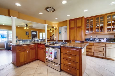 spacious kitchen with maple wood cabinetry throughout.